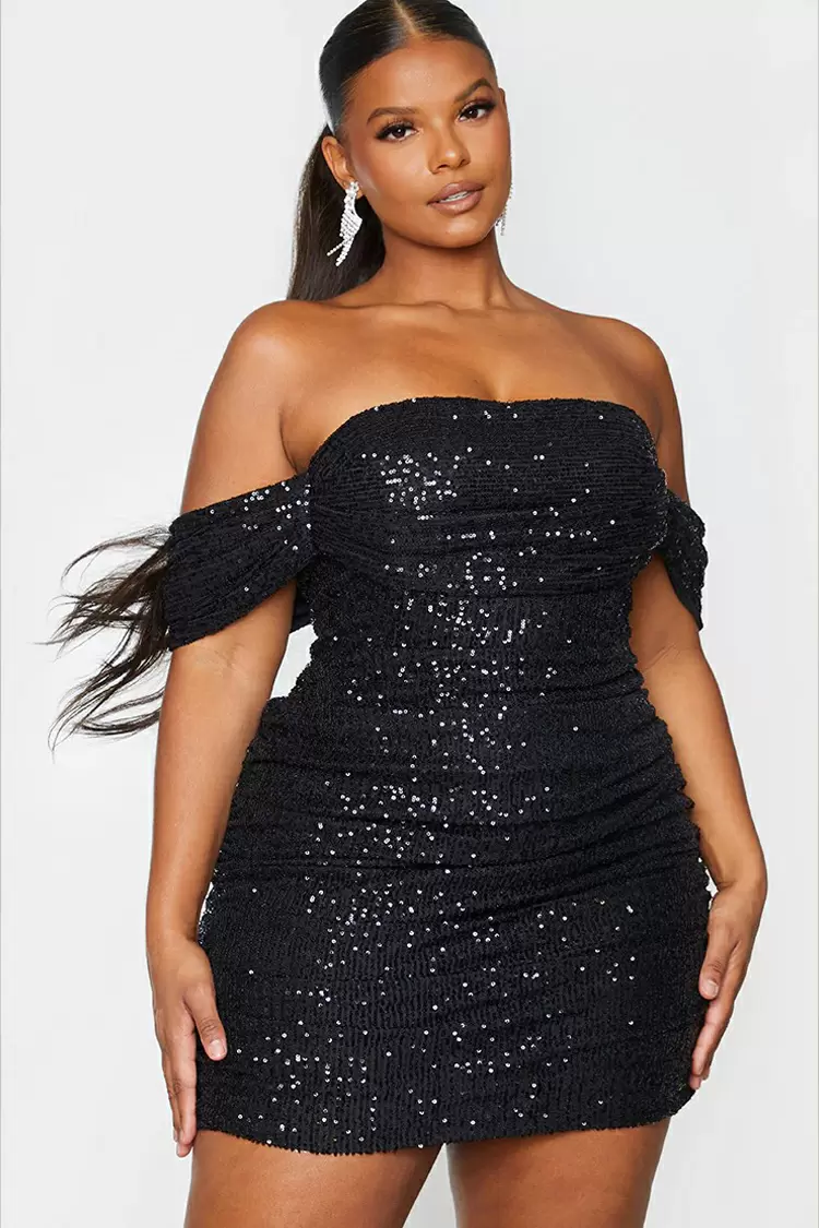 This classic black evening gown with feather embellishments exude a playful and sexy vibe.