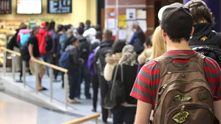 You're out shopping for clothes, and you're waiting in line to pay. What are you most likely to do while you are waiting?