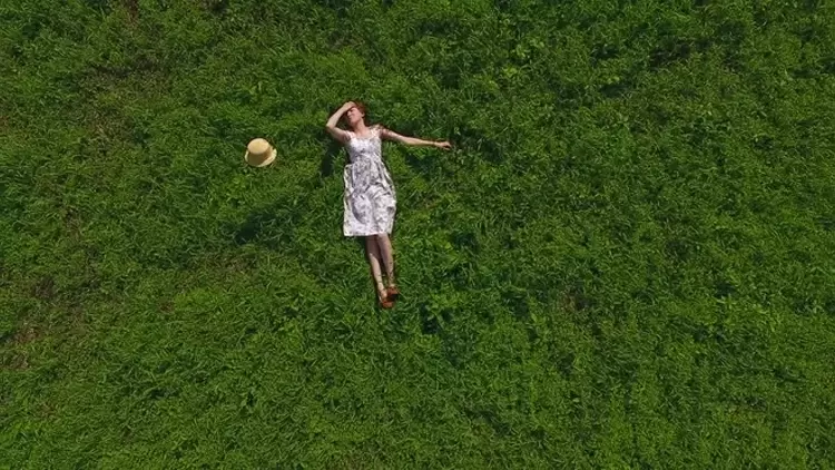 After six more months, nothing is happening. You're lying on the grass, gazing up at the clear blue sky on a lovely sunny day.  You feel as if someone is watching you from behind, and when you turn around, you see ____.